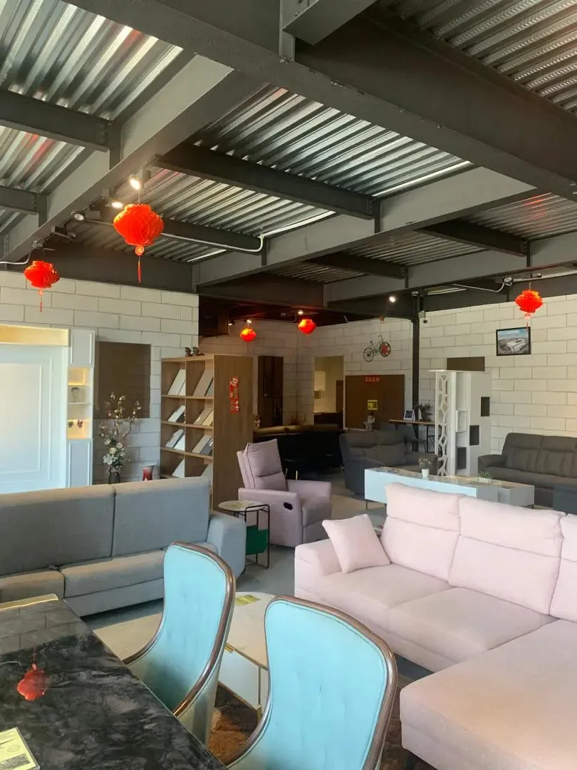 Modern living room with gray and white furniture, red lanterns, and a high ceiling — TD Furniture