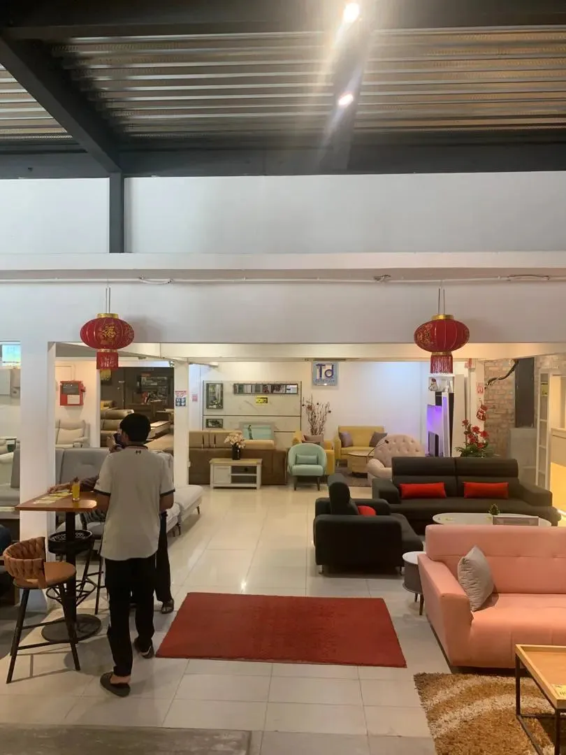 Interior of a furniture showroom with various sofas and decor items.