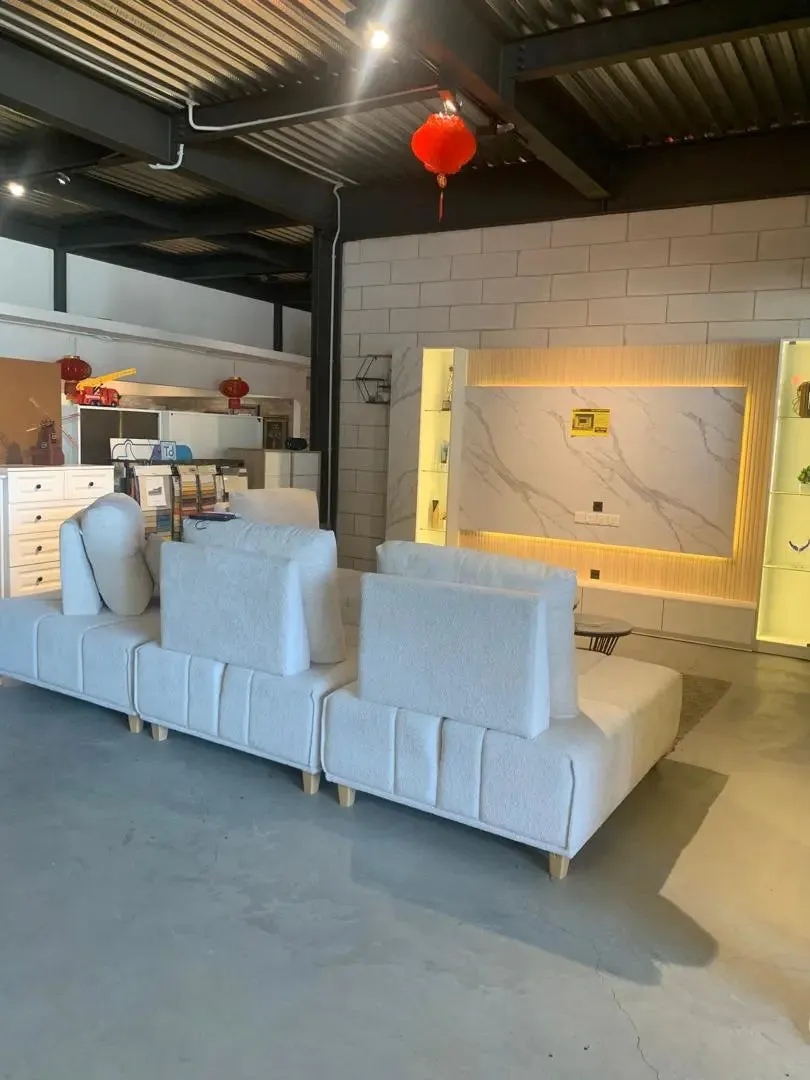 Gray sectional sofa in a modern living room setting with a red lantern hanging from the ceiling.
