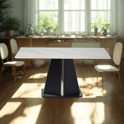 Elegant white marble table with black base styled in a bright dining space for a modern, luxurious look.
