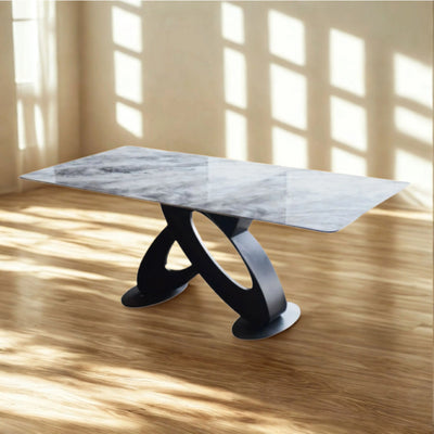 Modern luxury marble table styled in a bright dining interior, showcasing its sleek top and bold contrast base.